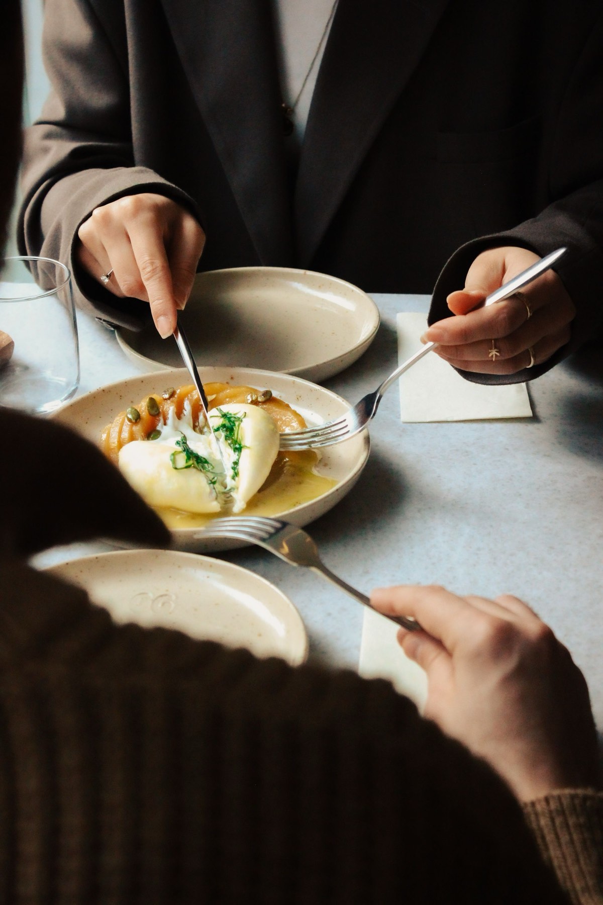 Guests laughing together at a restaurant table